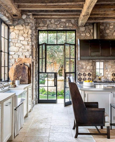 rustic stone walled kitchen with crittal doors 