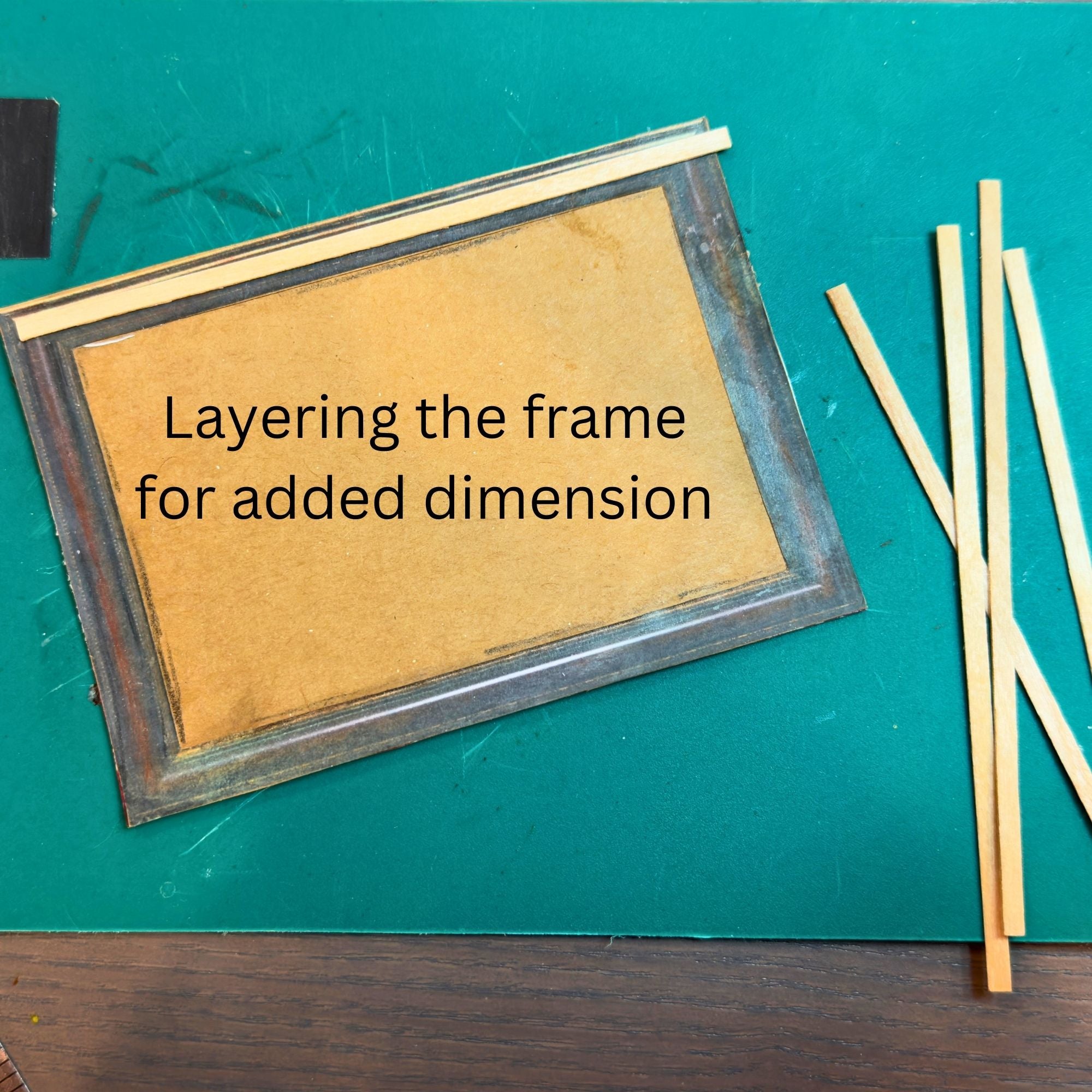 layering the frame with coffee stirrers