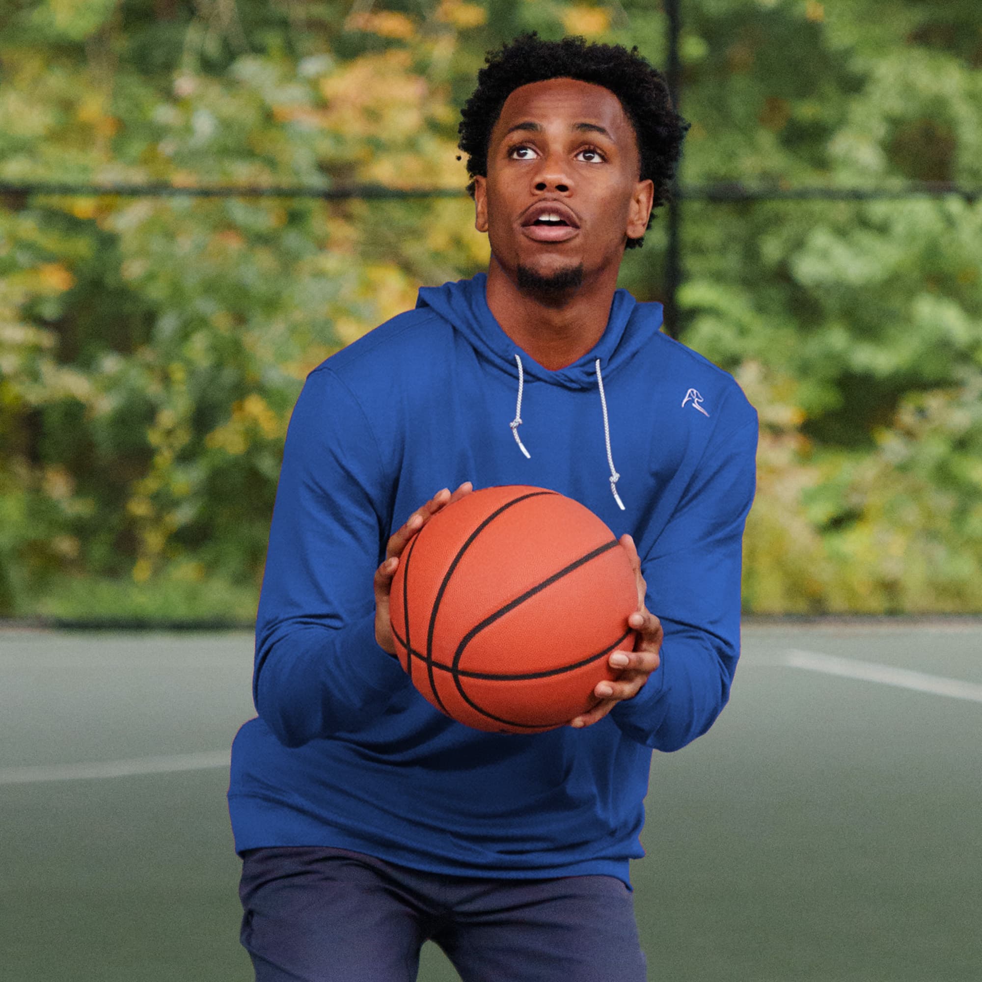 Bracket Buster playing basketball on the basketball court wearing The Point Guard Hoodie