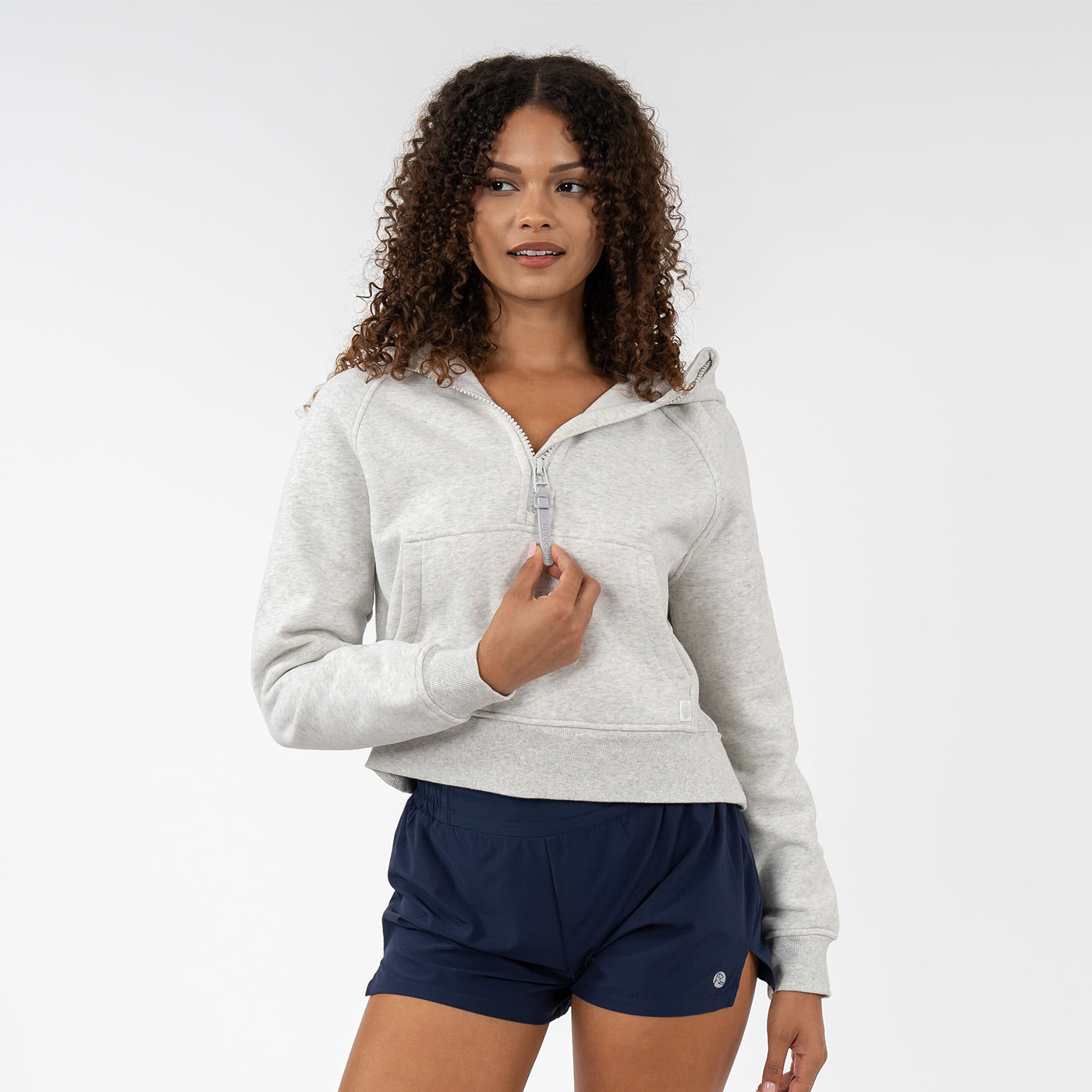 Woman in a heather light-grey sweatshirt featuring a soft, lightweight fabric, ideal for a relaxed and comfortable style.