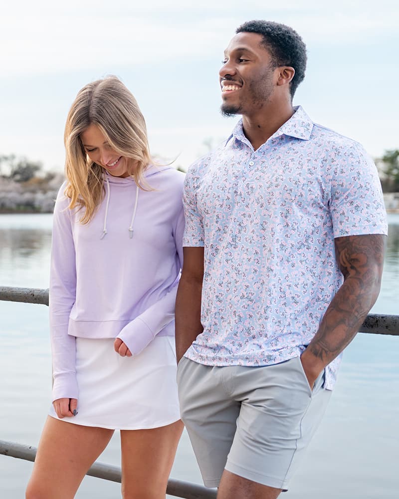 Men and woman in front of a lake wearing Rhoback apparel.