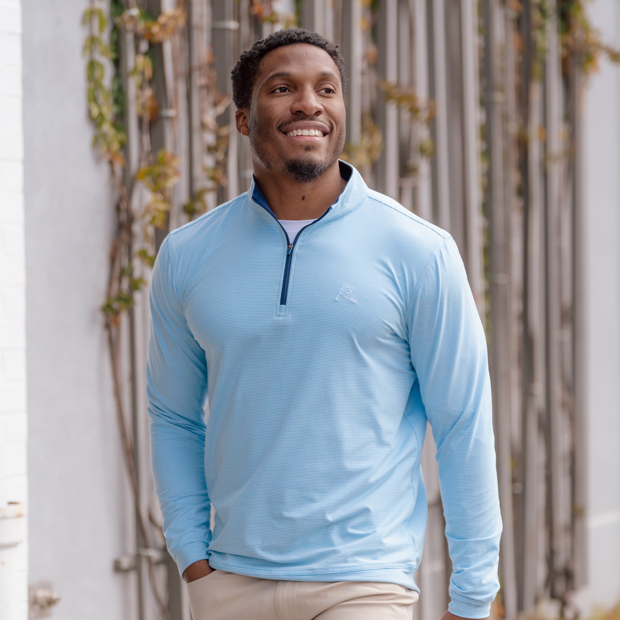 Man walking wearing The Bluetail Q-Zip