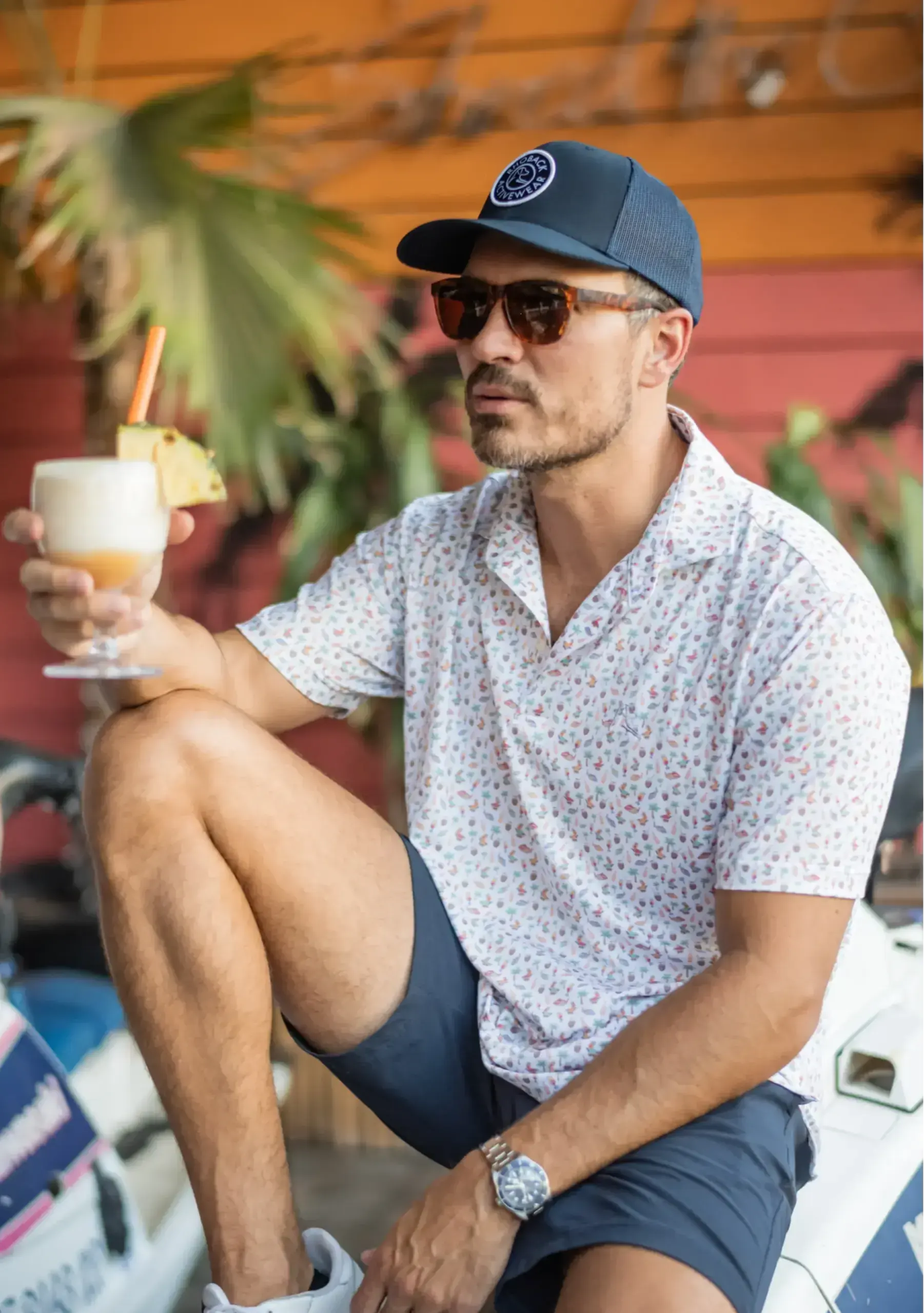 Dillon Cheverere holding a Pina Colada wearing The Willmon's Polo