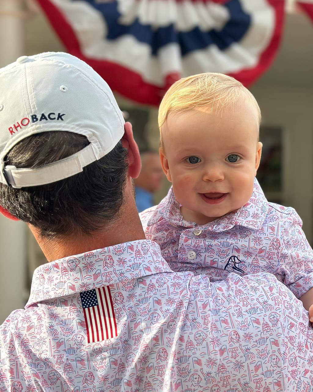 Father holding his baby wearing The American Icon and the Lil' American Icon