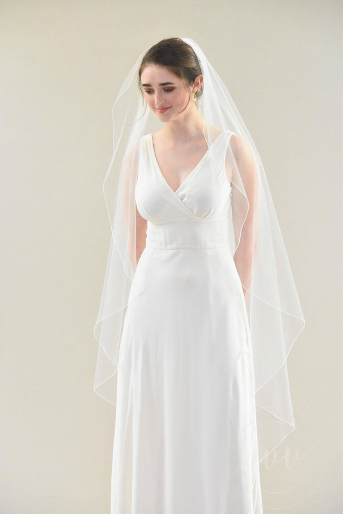 https://cdn.shopify.com/s/files/1/1367/2565/products/Angel-Cut-Waltz-Length-Veil-with-Pencil-Edge-2_bd9d0a33-3a95-4314-bc0c-64c4e61baa38_1024x1024.jpg?v=1658934115