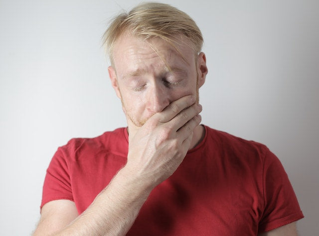 Man dealing with tooth injury as one of the toothache symptoms