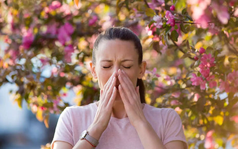 woman with allergies sneezing