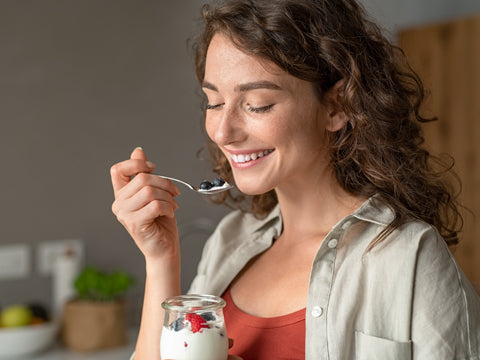 woman eating probiotic rich keifer yogurt food for bigger breast size