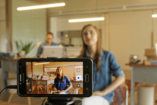 lady recording a video in an office setup