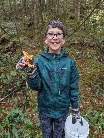 Eli proudly displays his first find of a nice Golden Chanterelle.