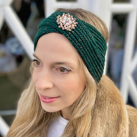 woman wearing green sparkle winter headband with gold pearl brooch