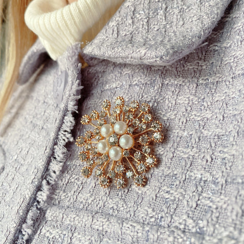 gold pearl and crystal brooch on checkered jacket