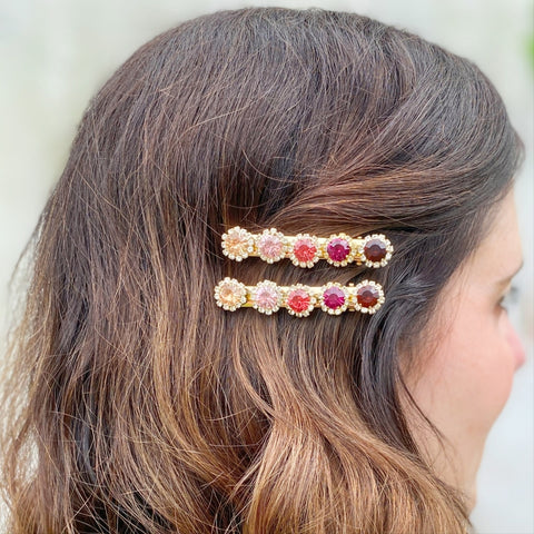 woman wearing colourful sparkly hair slides to hold one side of her hair back