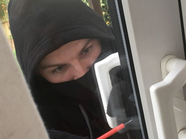 burglar breaking into patio door