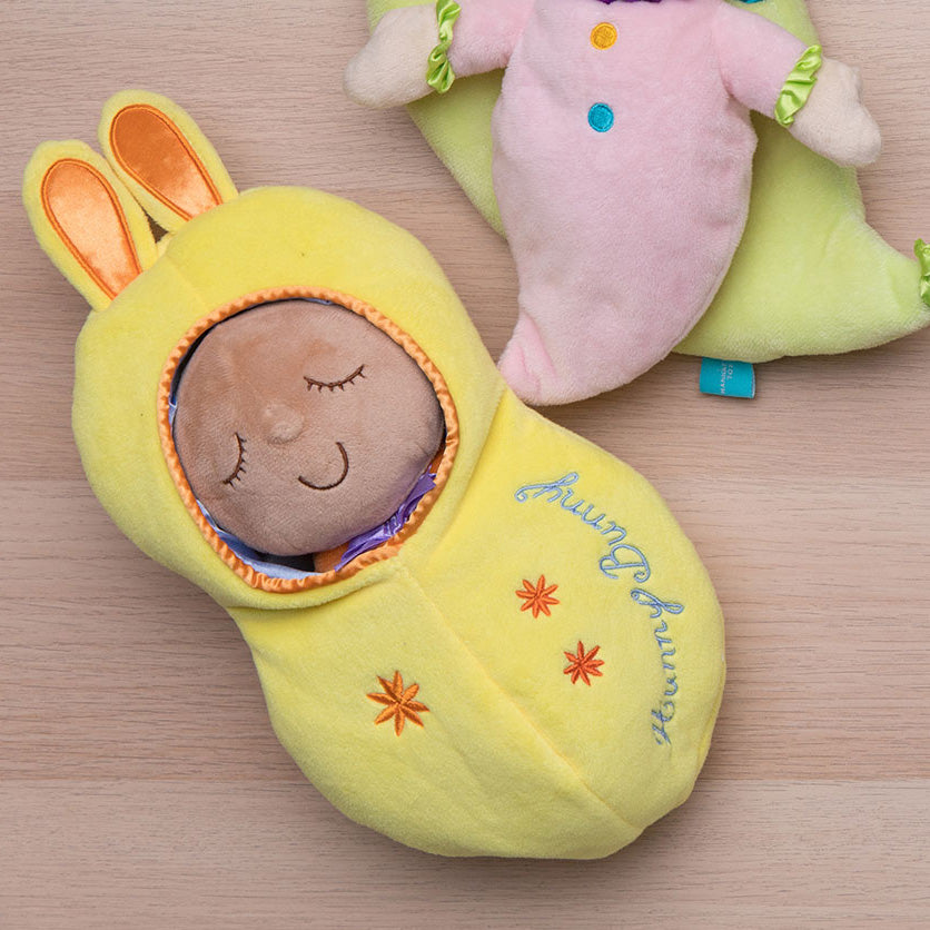 soft doll in bunny shaped fabric pod