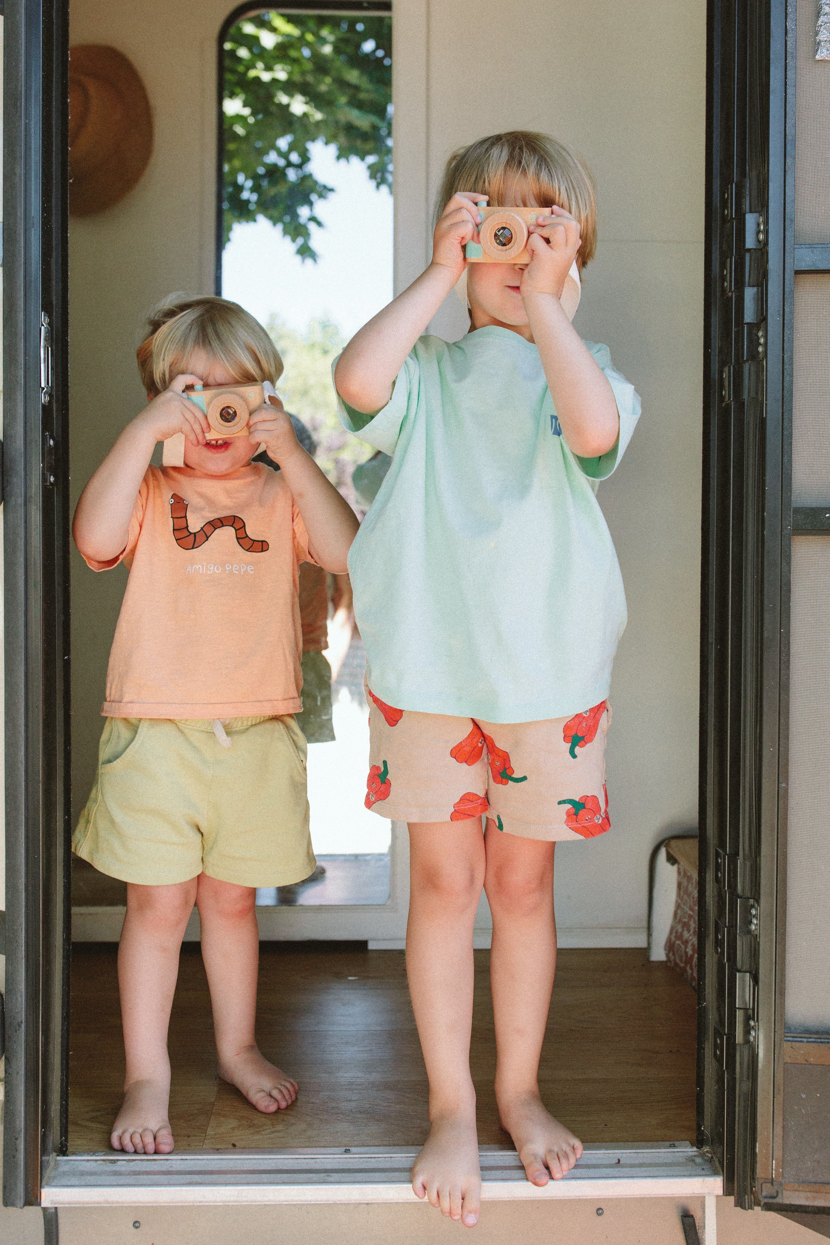 Boys enjoying imaginative play time with Manhattan Toy wood cameras.