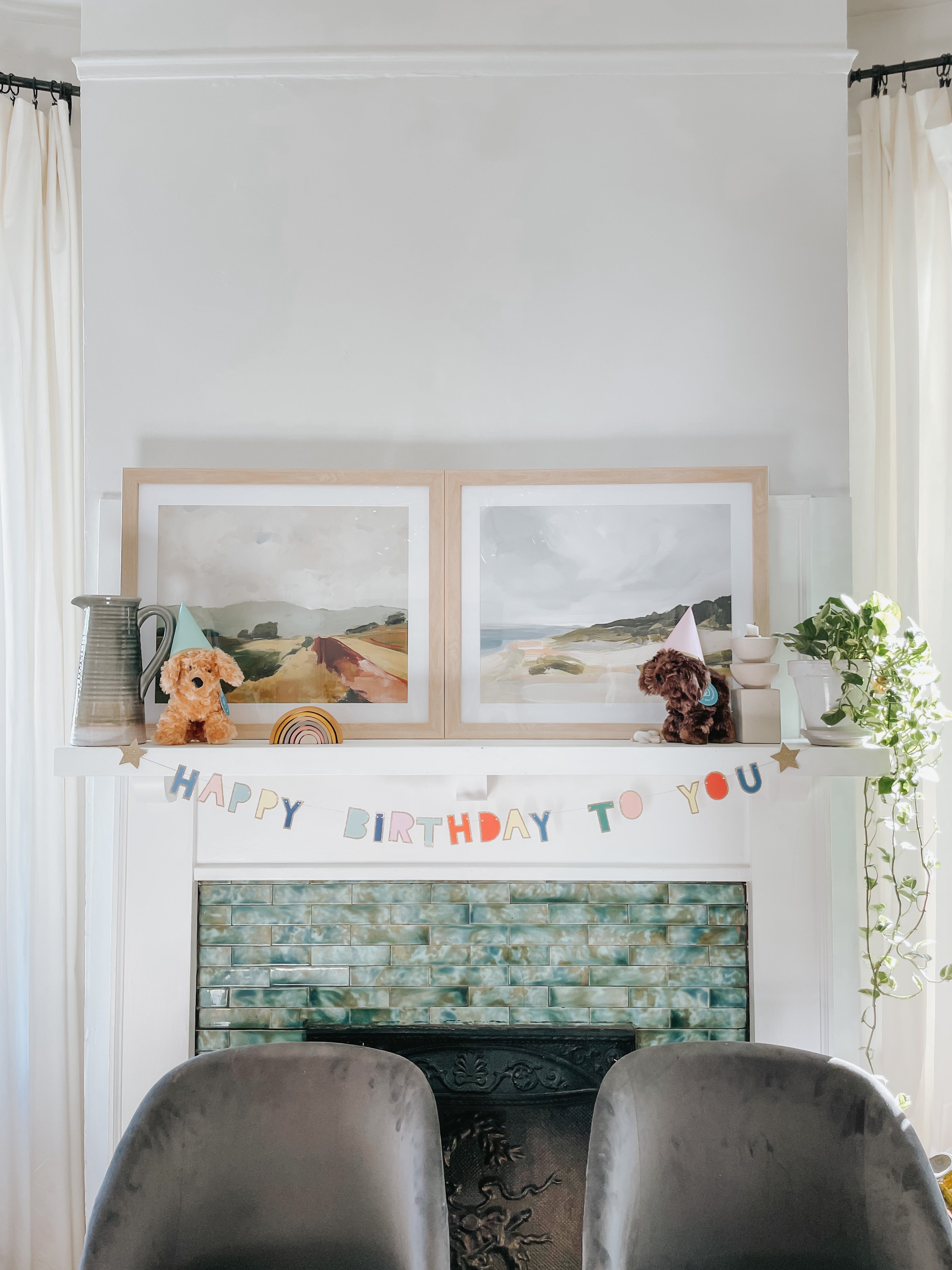 Stuffed animal dogs and happy birthday garland strung across fireplace mantle for party decor. Photo credit Lucky Andi.