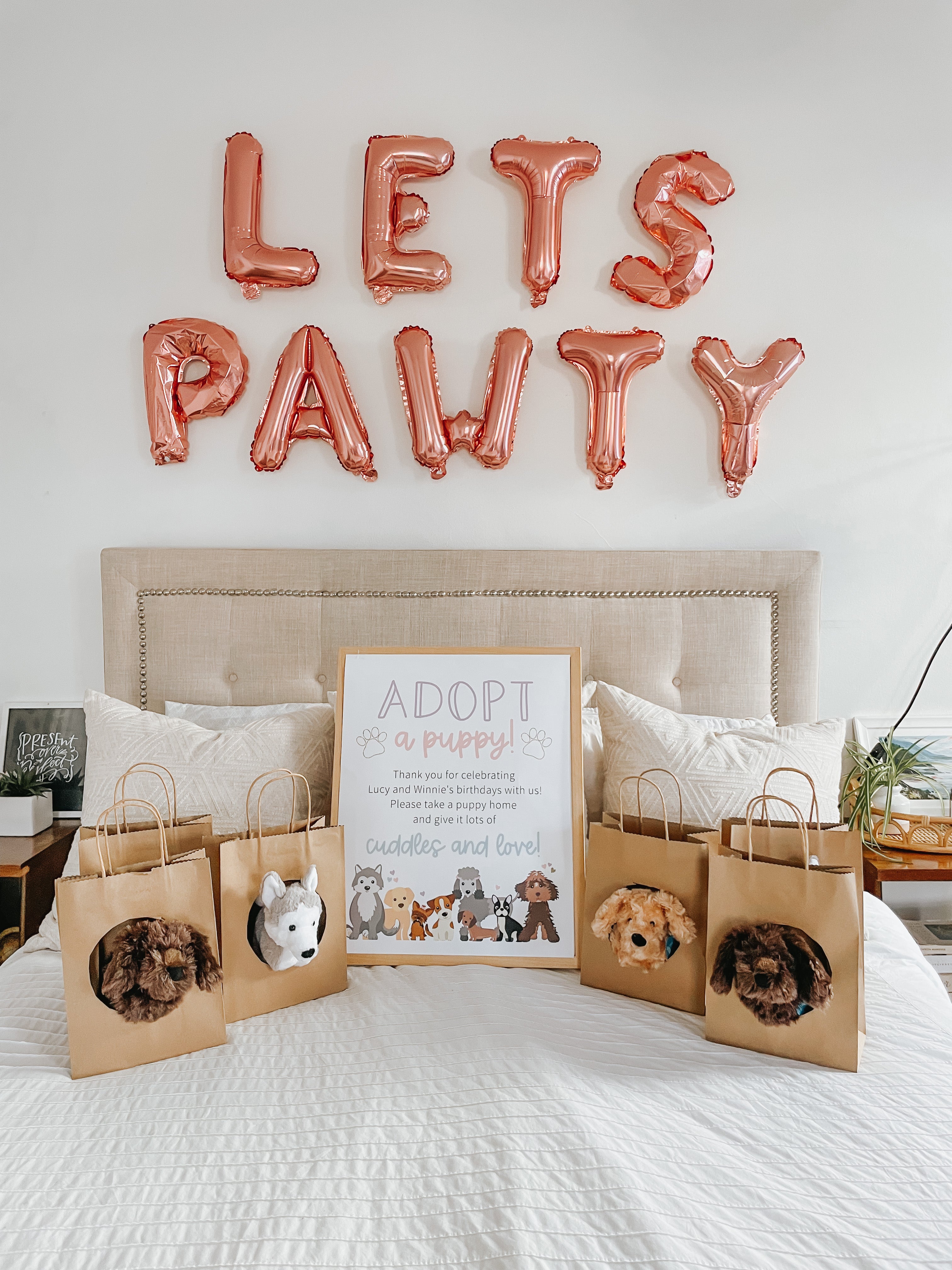 Adopt a puppy theme party with puppies in brown bags on bed. Photo credit to Lucky Andi.