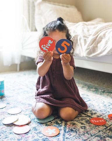 Young girl holding up number tiles from Subi game. Photo credit @ellen_wags on Instagram.