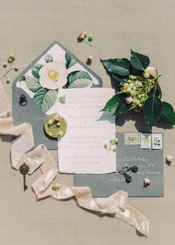 Sympathy letter flatlay with envelope, flowers, leaves and ribbon