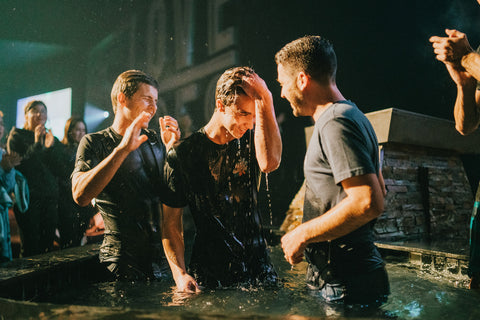 Young man getting baptized
