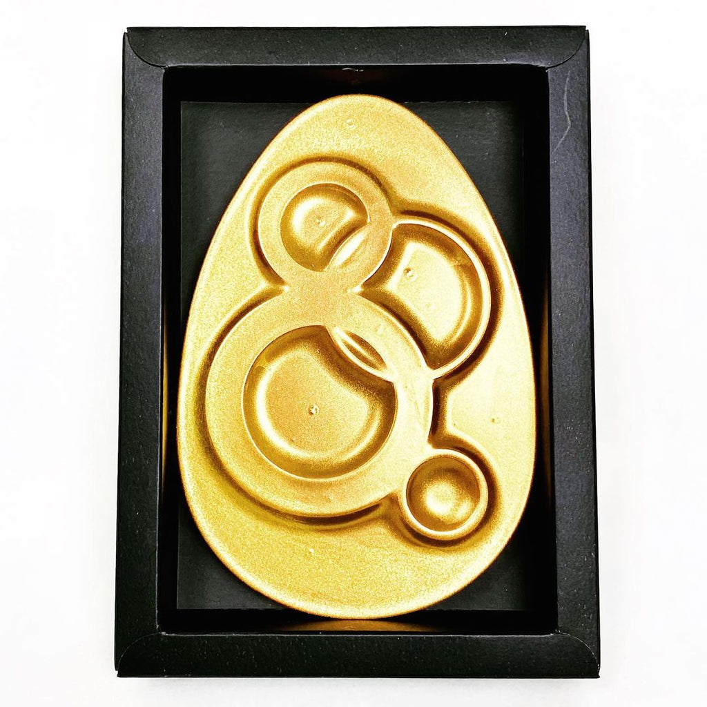 a flat gold chocolate easter egg made with the Mayku FormBox