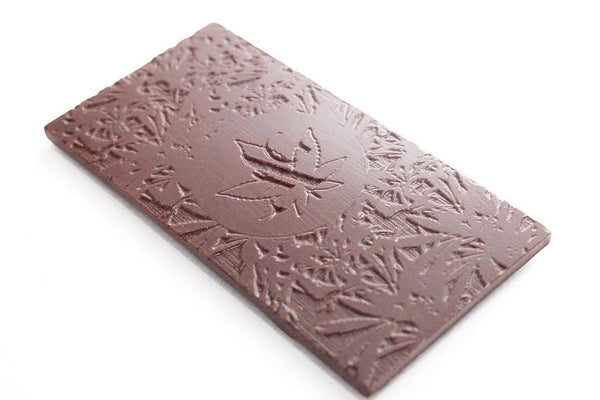 A custom made chocolate bar with the Atelier des Arts Gourmands logo on