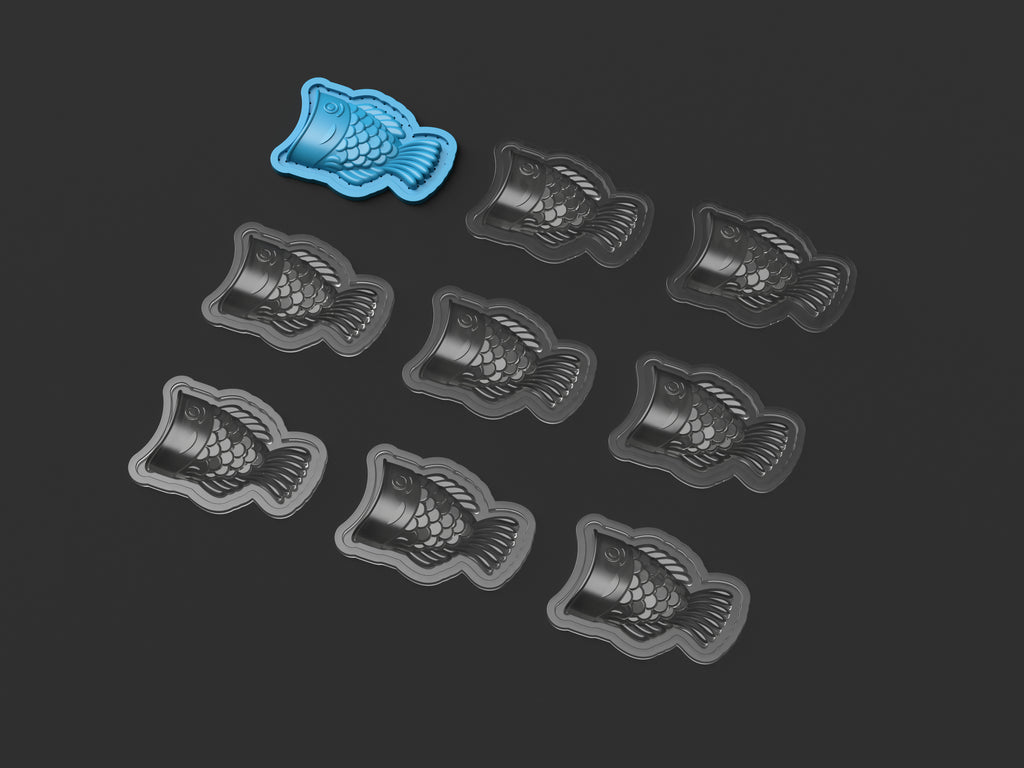 Eight Taiyaki vacuum-formed two-part molds and the original template displayed on a dark background
