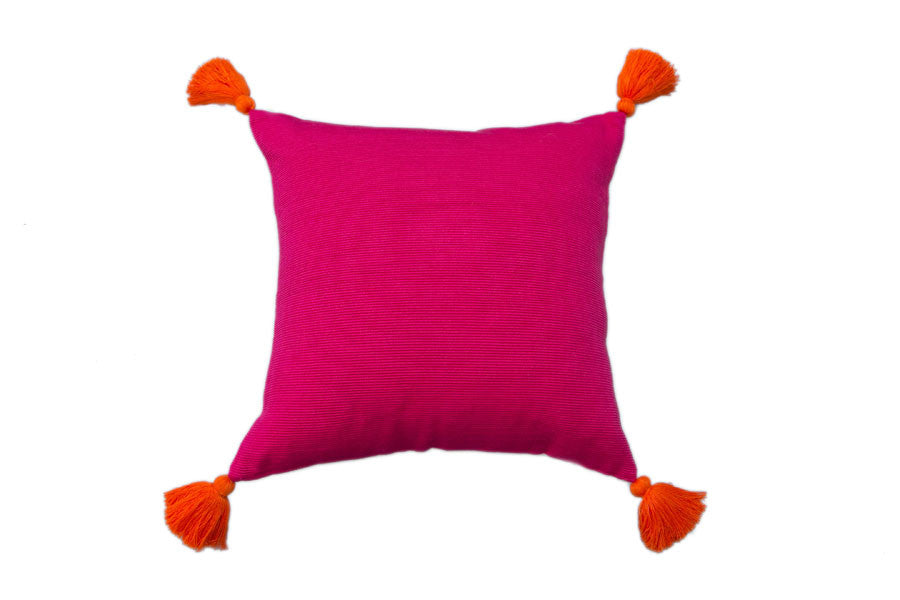 pink pillow with tassels