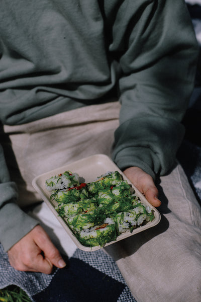 Image of eco-friendly disposable sushi packaging. A sugar cane compostable tray. 