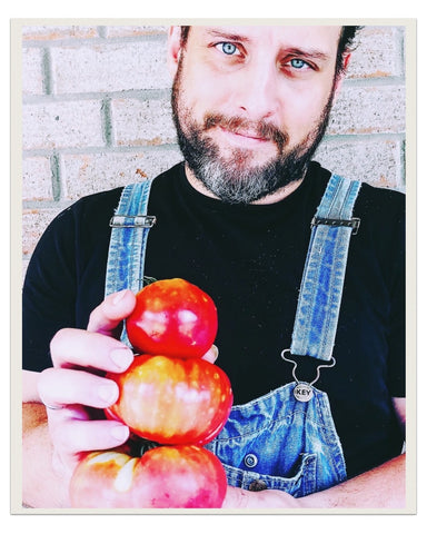 Matt holding fresh farm tomatoes