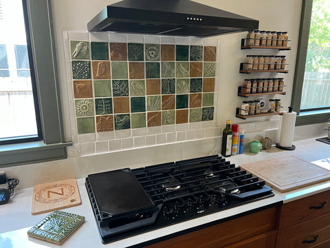 a multi-colored handmade tile kitchen backsplash