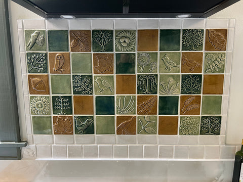 close up of brightly colored handmade tiles installed behind a kitchen range