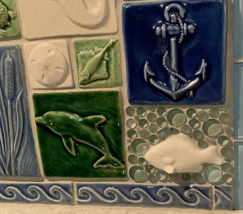 close up of ocean themed handmade tile montage in blue, green and white