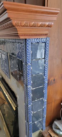 A fireplace featuring blue handmade tiles depicting the wildlife of montana