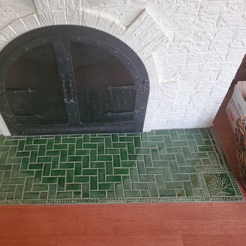 green handmade tile installed around a victorian fireplace