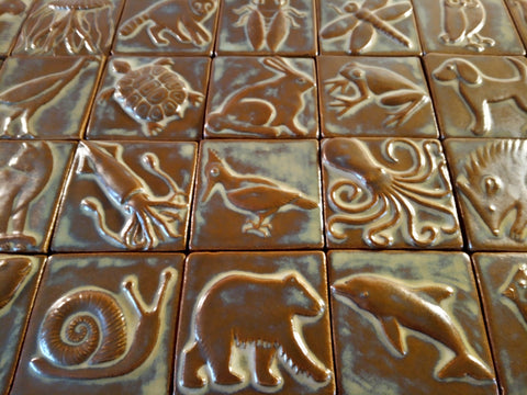 handmade animal tiles in a brown glaze