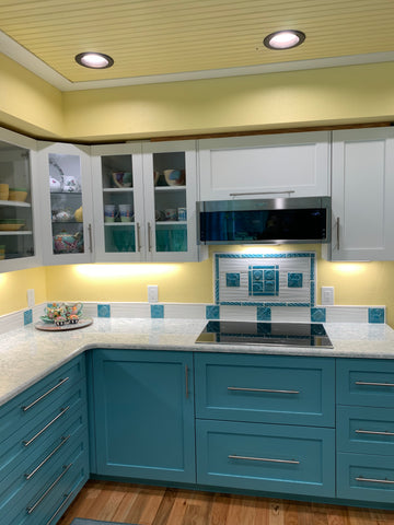 kitchen with turquoise cupboards and handmade tiles