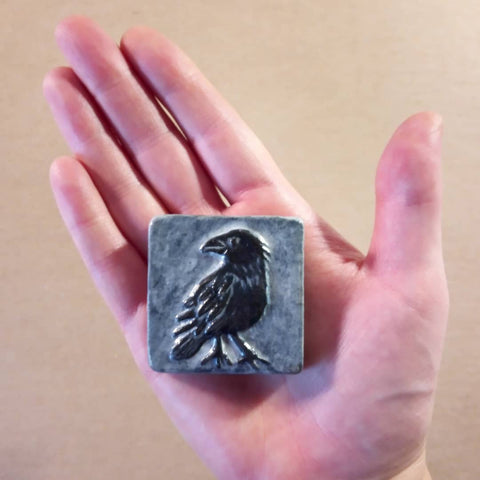 handmade crow tile in hand