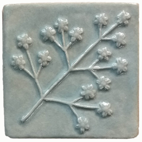 delicate floret four inch by four inch handmade tile in celadon glaze