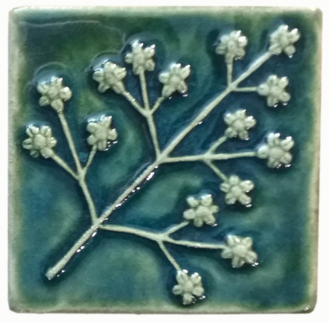 delicate floret four inch by four inch handmade tile in leaf green glaze