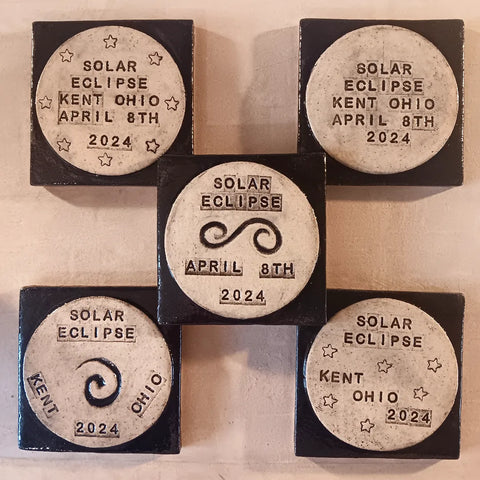black and white commemorative tiles for the solar total solar eclipse  on april 8th 2024