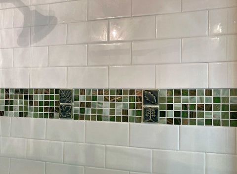tiled shower with subway tiles and a forest green stripe of glass and handmade tiles