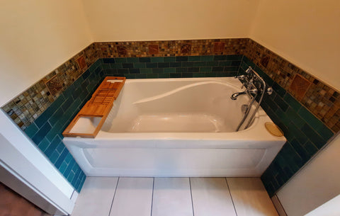 handmade and glass tiles around a bathtub