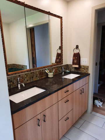 handmade tiles installed over a double sink in a bathroom