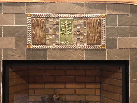 close up of handmade tiles installed over a fireplace insert