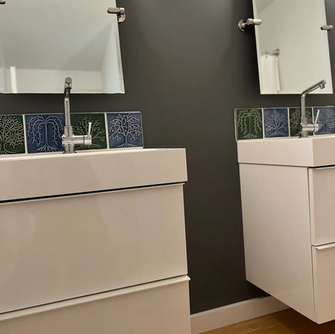 handmade tiles installed over two sinks in a bathroom