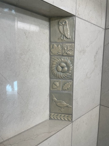 handmade tiles installed in a shower niche