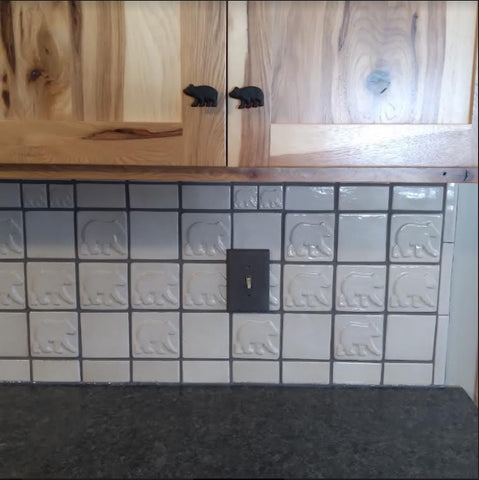 handmade bear tiles installed in a kitchen backsplash