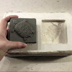 handmade tile depicting a turtle fresh out of a press mold